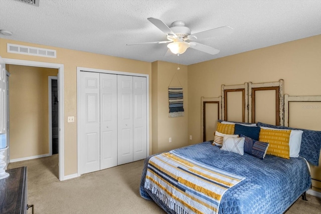2541 W Castle Rd, Citrus Springs, FL 34434 - carpeted bedroom with a closet, a ceiling fan, a textured ceiling, and baseboards