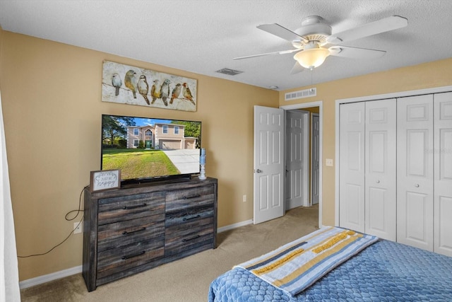 2541 W Castle Rd, Citrus Springs, FL 34434 - carpeted bedroom with a textured ceiling, baseboards, a closet, and a ceiling fan