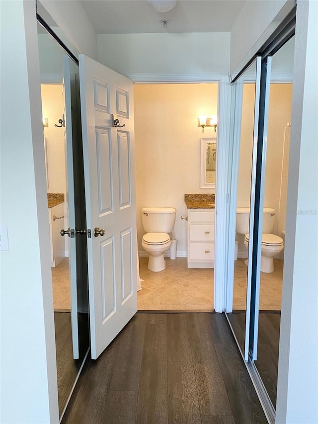 850 S Tamiami Trl Unit 424, Sarasota, FL 34236 - bathroom featuring toilet, wood finished floors, and vanity