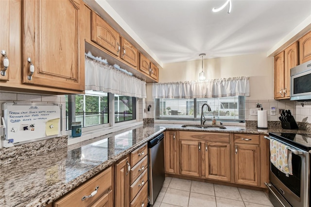 12101 Meadowbrook Ln, Hudson, FL 34667 - kitchen with a sink, appliances with stainless steel finishes, decorative backsplash, and brown cabinetry