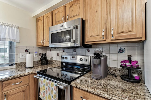 12101 Meadowbrook Ln, Hudson, FL 34667 - kitchen featuring appliances with stainless steel finishes, backsplash, and light stone countertops