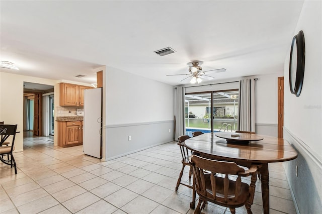 12101 Meadowbrook Ln, Hudson, FL 34667 - dining room with light tile patterned floors and ceiling fan