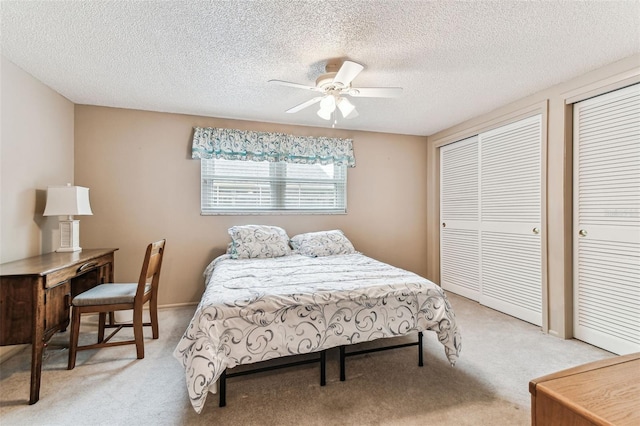 12101 Meadowbrook Ln, Hudson, FL 34667 - bedroom with light carpet, two closets, a textured ceiling, and a ceiling fan