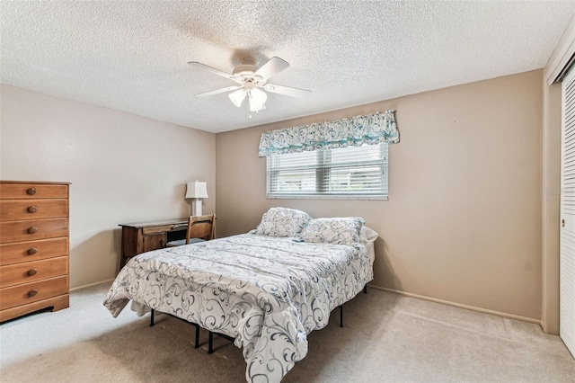 12101 Meadowbrook Ln, Hudson, FL 34667 - carpeted bedroom featuring a closet, a ceiling fan, a textured ceiling, and baseboards