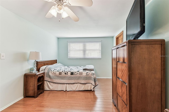 12101 Meadowbrook Ln, Hudson, FL 34667 - bedroom with light wood-style flooring, baseboards, and ceiling fan