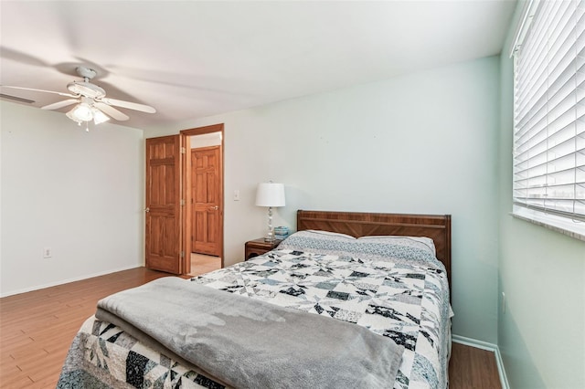 12101 Meadowbrook Ln, Hudson, FL 34667 - bedroom with multiple windows, wood finished floors, and baseboards