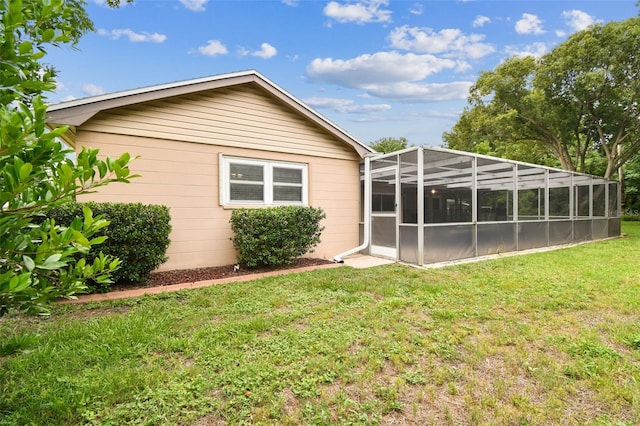 12101 Meadowbrook Ln, Hudson, FL 34667 - rear view of house featuring a lawn and glass enclosure