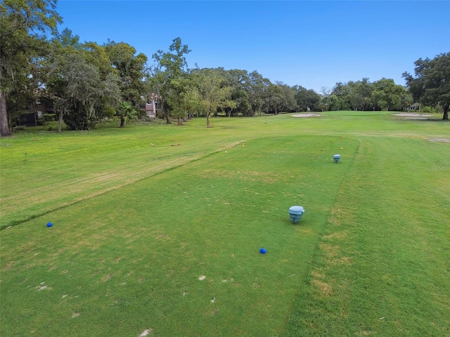 12101 Meadowbrook Ln, Hudson, FL 34667 - view of community featuring view of wooded area, golf course view, and a yard