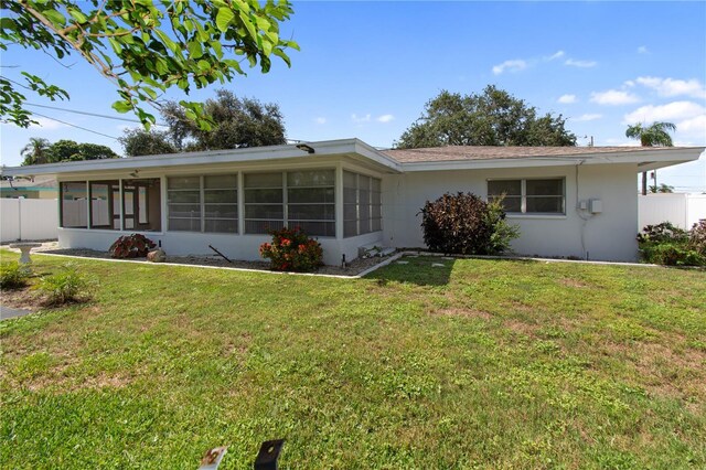 13898 Jamaica Dr, Seminole, FL 33776 - view of front of property with a sunroom and stucco siding