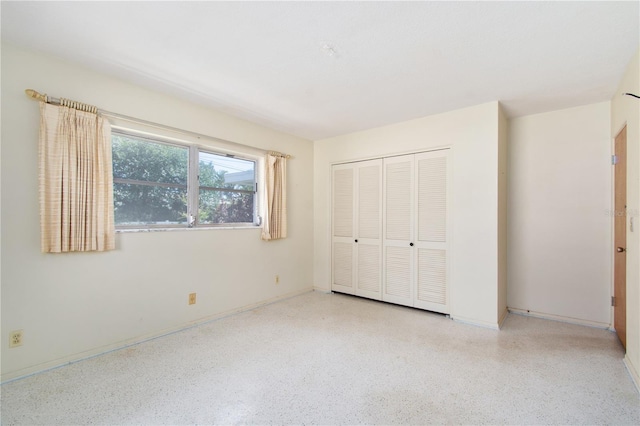 13898 Jamaica Dr, Seminole, FL 33776 - unfurnished bedroom with speckle patterned floor and a closet