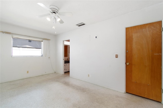 13898 Jamaica Dr, Seminole, FL 33776 - unfurnished room with ceiling fan and dark speckled floor