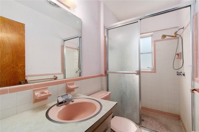13898 Jamaica Dr, Seminole, FL 33776 - full bath with a stall shower, vanity, and tile walls