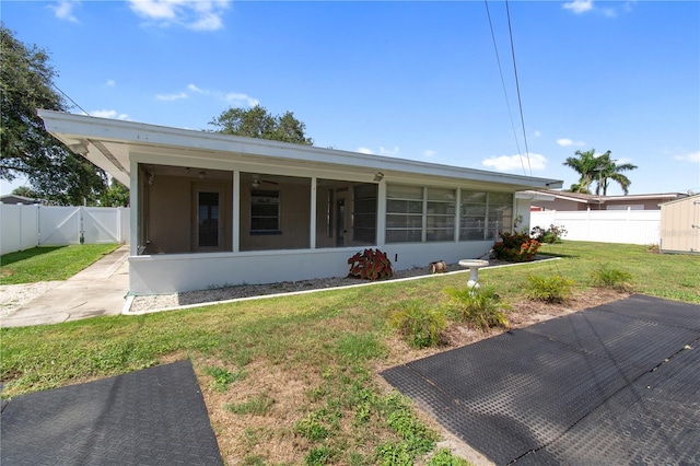 13898 Jamaica Dr, Seminole, FL 33776 - view of front facade with a sunroom, a fenced backyard, and a gate