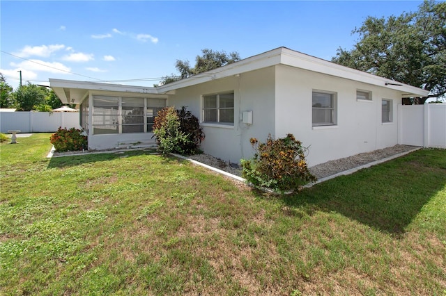 13898 Jamaica Dr, Seminole, FL 33776 - back of property with stucco siding and a sunroom