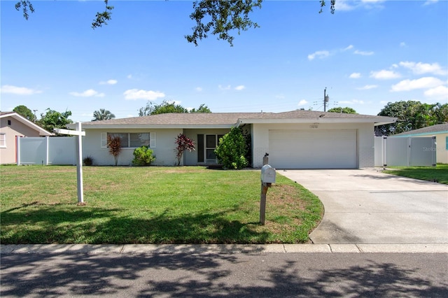 13898 Jamaica Dr, Seminole, FL 33776 - ranch-style house with an attached garage, driveway, and a gate