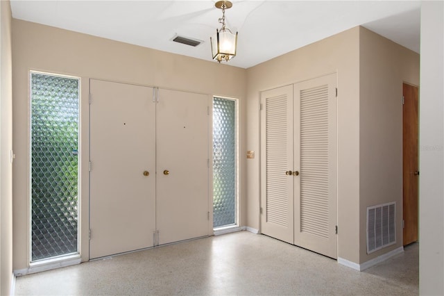 13898 Jamaica Dr, Seminole, FL 33776 - foyer entrance featuring dark aggregate flooring