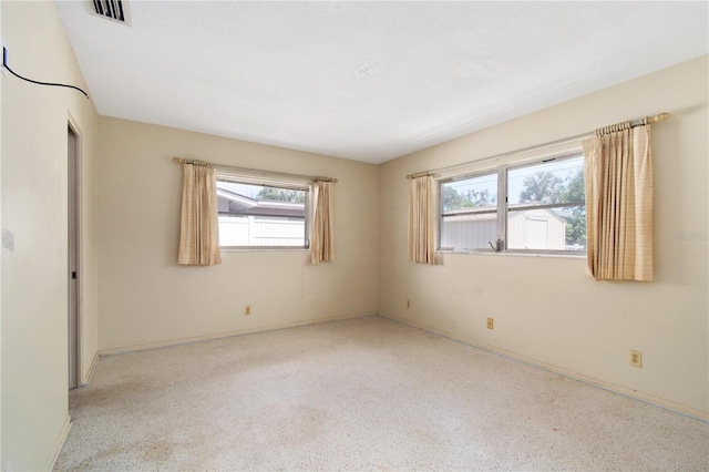 13898 Jamaica Dr, Seminole, FL 33776 - empty room with speckle patterned floor and baseboards