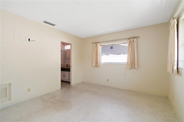13898 Jamaica Dr, Seminole, FL 33776 - empty room featuring dark aggregate flooring and baseboards