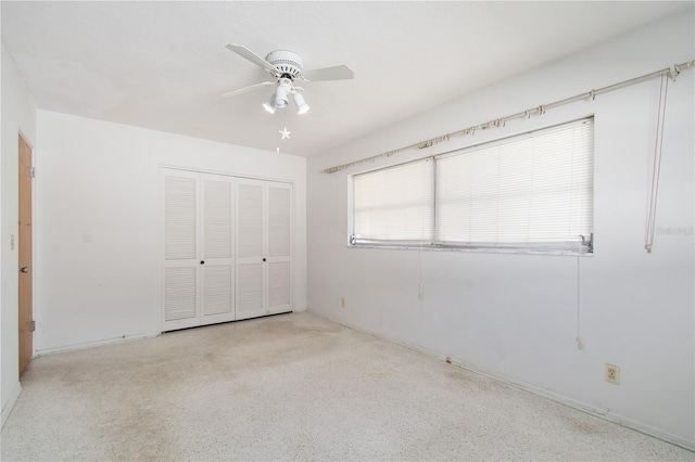 13898 Jamaica Dr, Seminole, FL 33776 - unfurnished bedroom with a closet, a ceiling fan, and speckled floor
