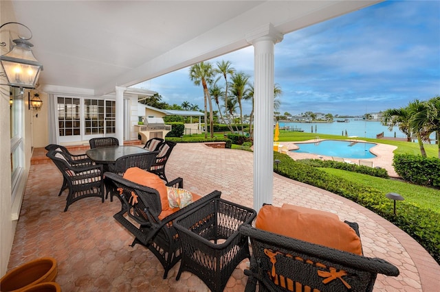 224 Harbor View Ln, Largo, FL 33770 - view of patio / terrace featuring an outdoor pool, outdoor dining area, and a water view