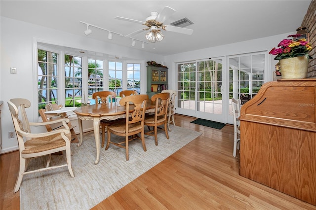 224 Harbor View Ln, Largo, FL 33770 - dining space with light wood-type flooring, ceiling fan, and rail lighting