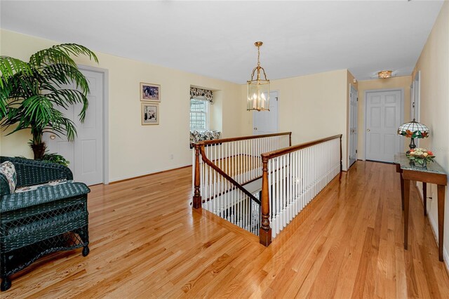 224 Harbor View Ln, Largo, FL 33770 - hallway featuring an upstairs landing, light wood-style floors, and a chandelier