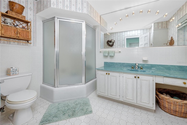 224 Harbor View Ln, Largo, FL 33770 - bathroom with wallpapered walls, vanity, tile patterned floors, tile walls, and shower / bath combination with glass door