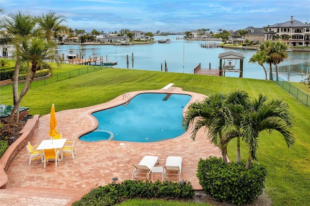 224 Harbor View Ln, Largo, FL 33770 - view of pool featuring boat lift, a boat dock, a water view, a diving board, and a patio
