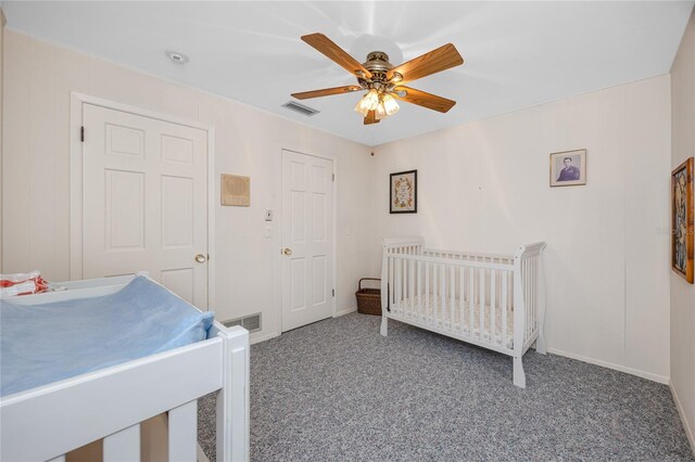 224 Harbor View Ln, Largo, FL 33770 - bedroom with carpet flooring, a ceiling fan, and a crib
