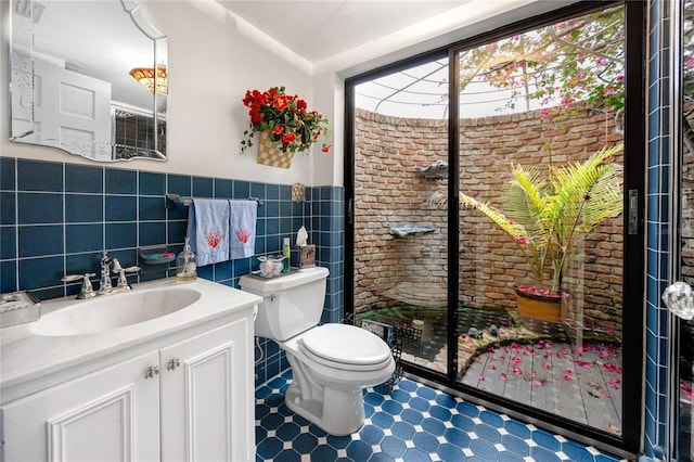 224 Harbor View Ln, Largo, FL 33770 - bathroom with vanity, tile patterned floors, tile walls, and wainscoting