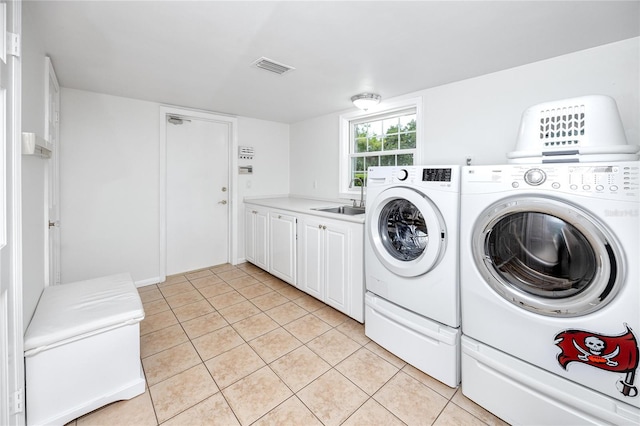 224 Harbor View Ln, Largo, FL 33770 - washroom featuring cabinet space, independent washer and dryer, and light tile patterned floors