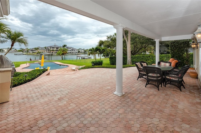 224 Harbor View Ln, Largo, FL 33770 - view of patio with an outdoor pool, a water view, and outdoor dining space