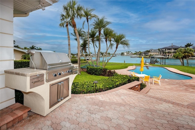 224 Harbor View Ln, Largo, FL 33770 - view of patio / terrace featuring area for grilling, a water view, an outdoor pool, and a boat dock