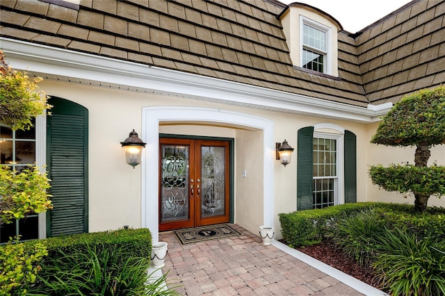 224 Harbor View Ln, Largo, FL 33770 - doorway to property with french doors and stucco siding
