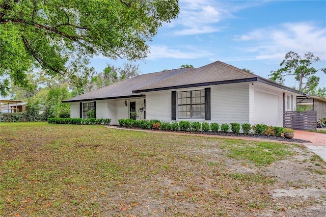 9615 Raiden Ln, Riverview, FL 33569 - view of front facade with brick siding, a garage, roof with shingles, and a front lawn