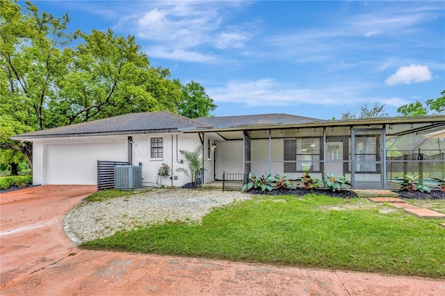 9615 Raiden Ln, Riverview, FL 33569 - ranch-style house with driveway, a garage, a front yard, central AC unit, and brick siding
