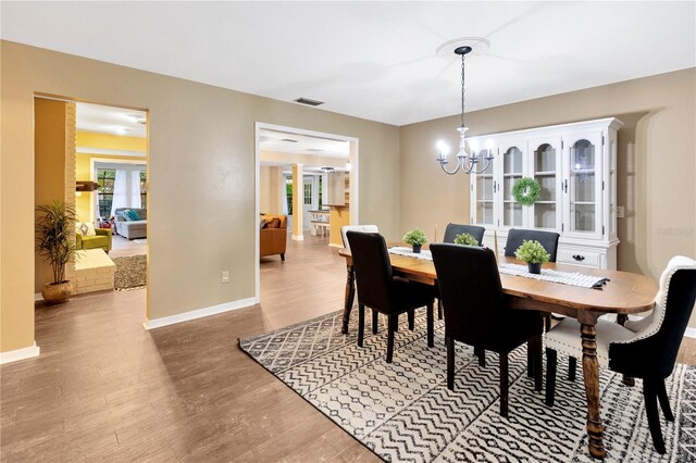 9615 Raiden Ln, Riverview, FL 33569 - dining space featuring a chandelier, wood finished floors, and baseboards