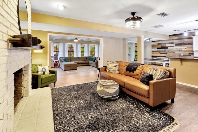 9615 Raiden Ln, Riverview, FL 33569 - living room featuring wood finished floors, a fireplace, ceiling fan, and baseboards