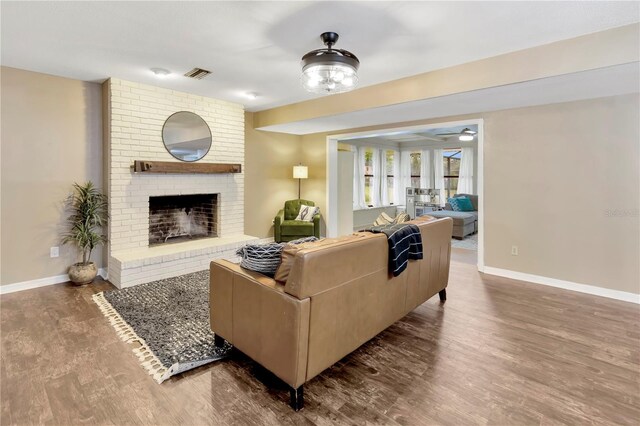 9615 Raiden Ln, Riverview, FL 33569 - living room with baseboards, wood finished floors, a fireplace, and ceiling fan