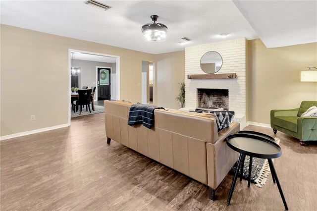 9615 Raiden Ln, Riverview, FL 33569 - living area with baseboards, wood finished floors, and a brick fireplace