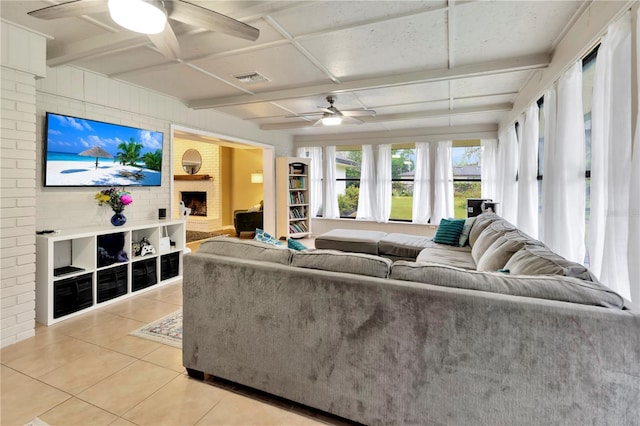 9615 Raiden Ln, Riverview, FL 33569 - living room featuring a ceiling fan, light tile patterned floors, coffered ceiling, a large fireplace, and beamed ceiling