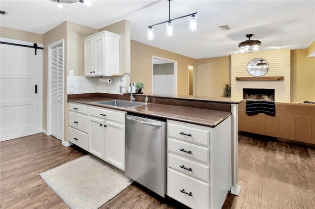 9615 Raiden Ln, Riverview, FL 33569 - kitchen featuring a sink, dishwasher, open floor plan, dark countertops, and a peninsula