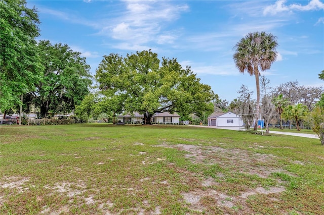 9615 Raiden Ln, Riverview, FL 33569 - view of grassy yard with view of wooded area