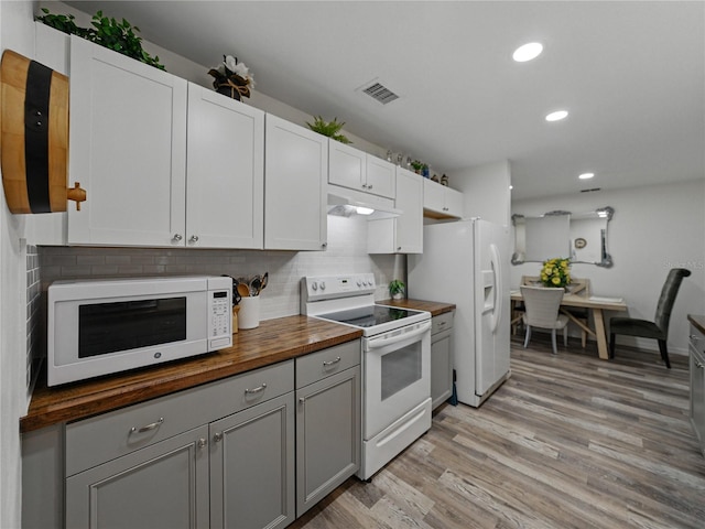 140 Morrow Cir, Brandon, FL 33510 - kitchen featuring white appliances, butcher block counters, under cabinet range hood, tasteful backsplash, and light wood-style floors