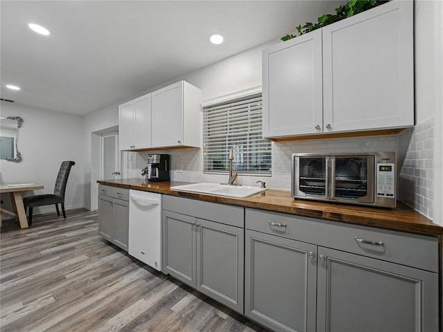 140 Morrow Cir, Brandon, FL 33510 - kitchen with wooden counters, white dishwasher, a sink, gray cabinetry, and recessed lighting