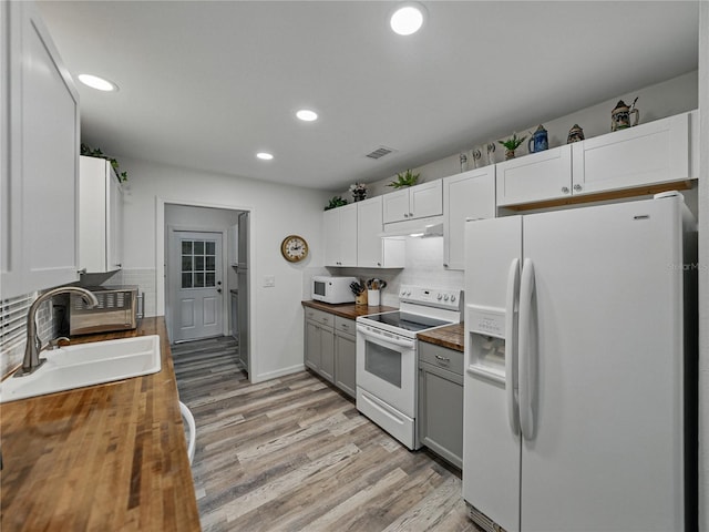 140 Morrow Cir, Brandon, FL 33510 - kitchen featuring white appliances, wooden counters, a sink, decorative backsplash, and recessed lighting