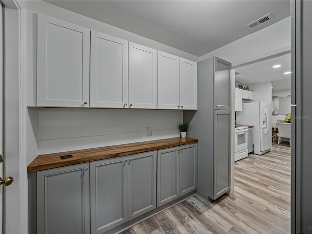 140 Morrow Cir, Brandon, FL 33510 - kitchen with butcher block counters, white appliances, light wood finished floors, and gray cabinetry