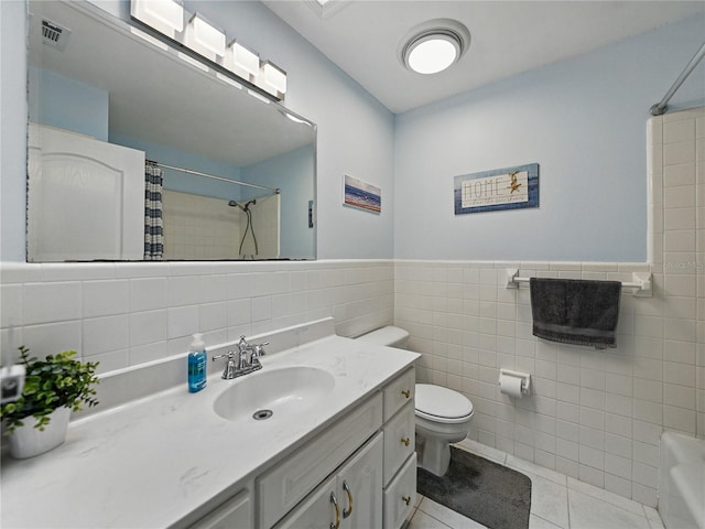 140 Morrow Cir, Brandon, FL 33510 - bathroom with tile walls, vanity, toilet, tile patterned flooring, and wainscoting