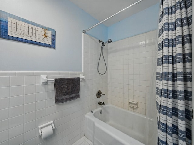 140 Morrow Cir, Brandon, FL 33510 - bathroom featuring shower / bath combo with shower curtain, tile walls, tile patterned flooring, and a wainscoted wall