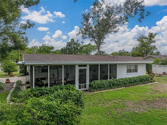 140 Morrow Cir, Brandon, FL 33510 - back of property featuring a sunroom and a shingled roof